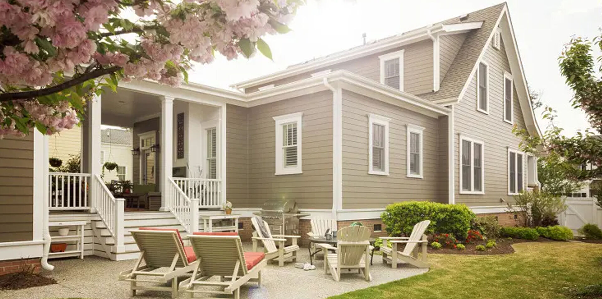 A welcoming home with a green lawn and outdoor seating, from Stine’s inspiration imagery